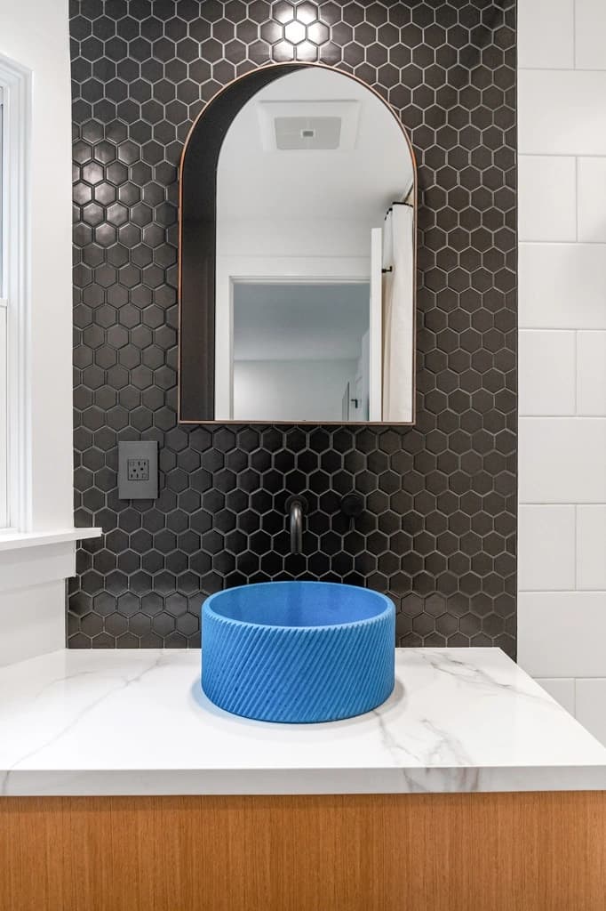 Bathroom with sink, faucet, mirror, vanity and tile